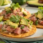 Tuna and avocado tostadas with lime, cilantro, and crispy tortillas.